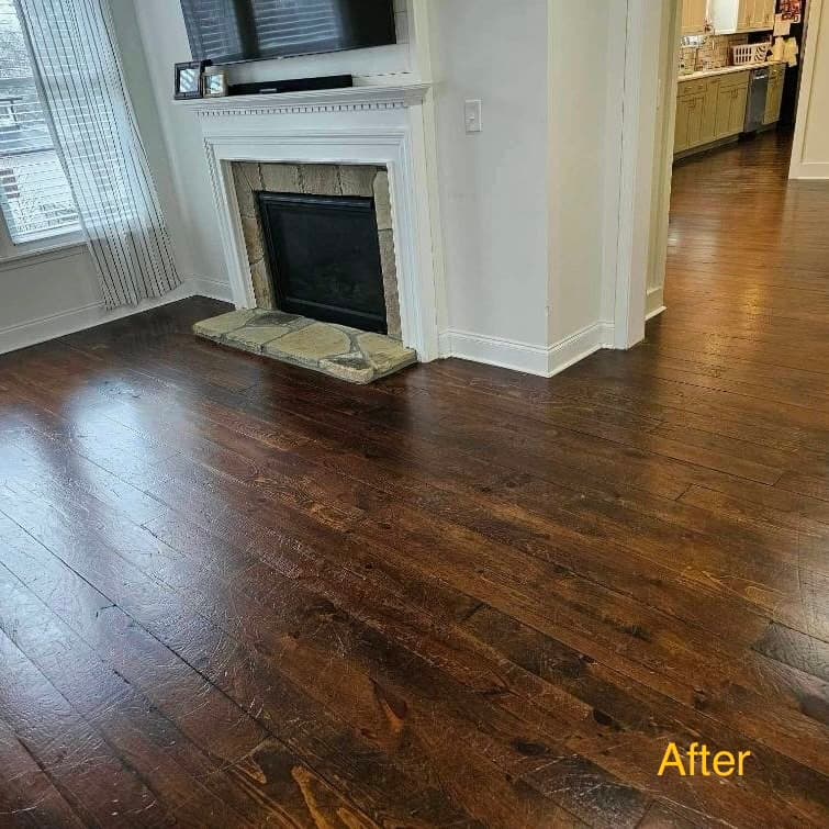 Dark hardwood floor near fireplace — restored after heavy scratches